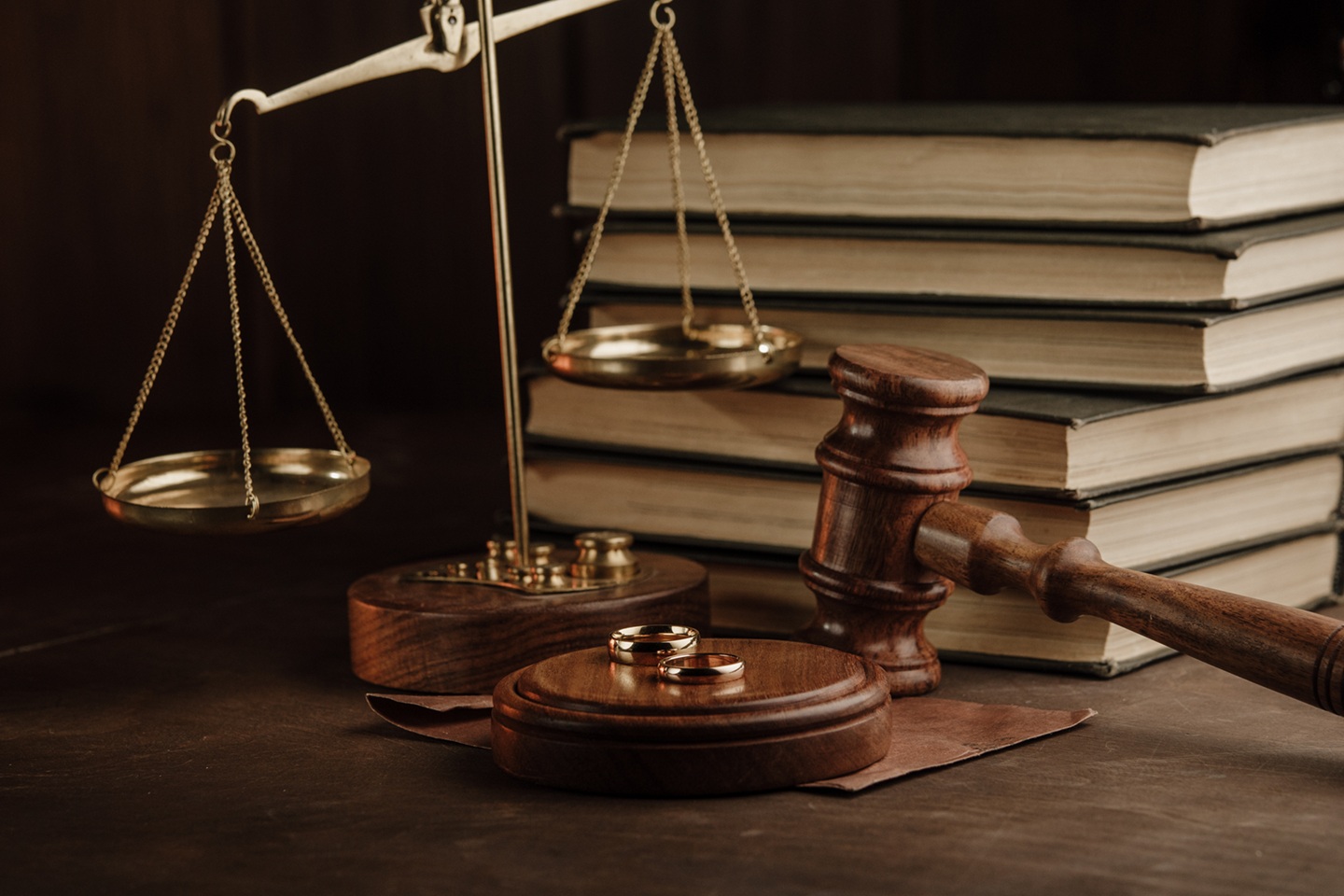 Divorce and separation concept. Judge gavel and golden rings in notary public office.